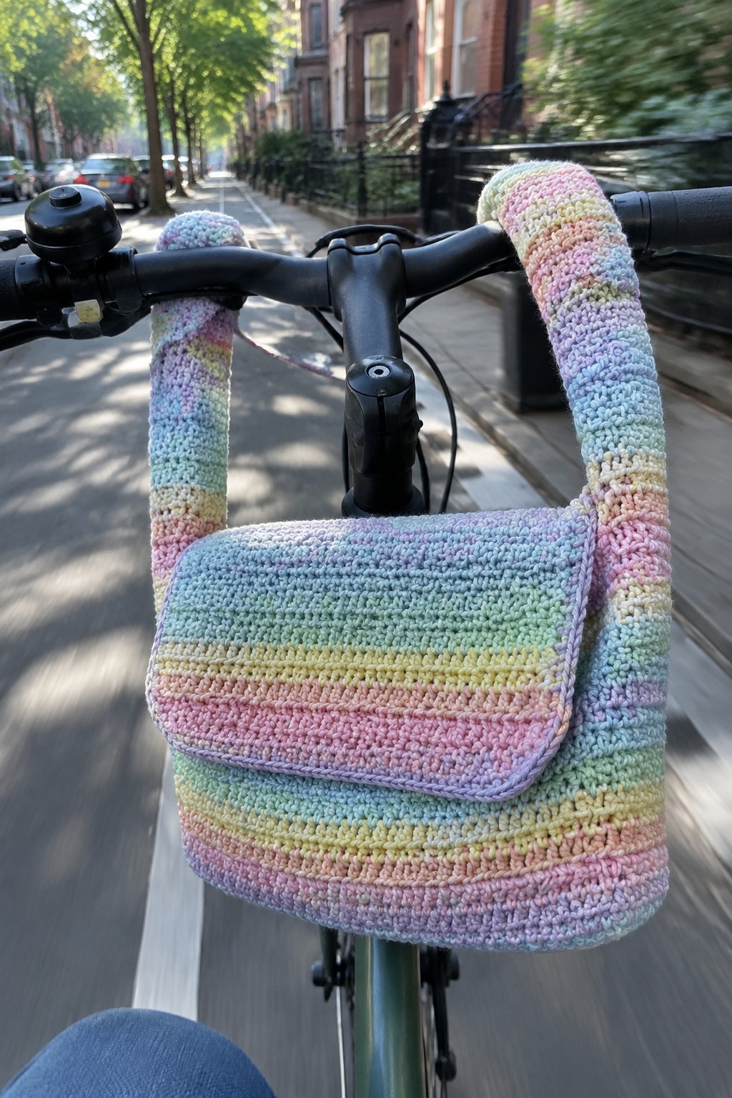 Rainbow crocheted handlebar covers with matching pouch on bicycle