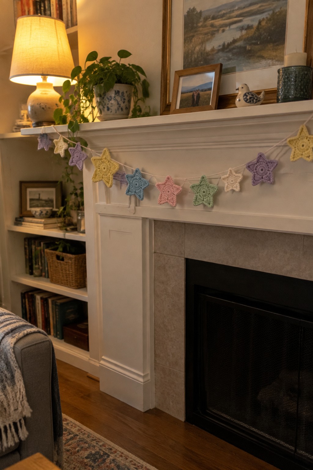 Colorful crocheted star garland draped across a white fireplace mantel in a cozy room.