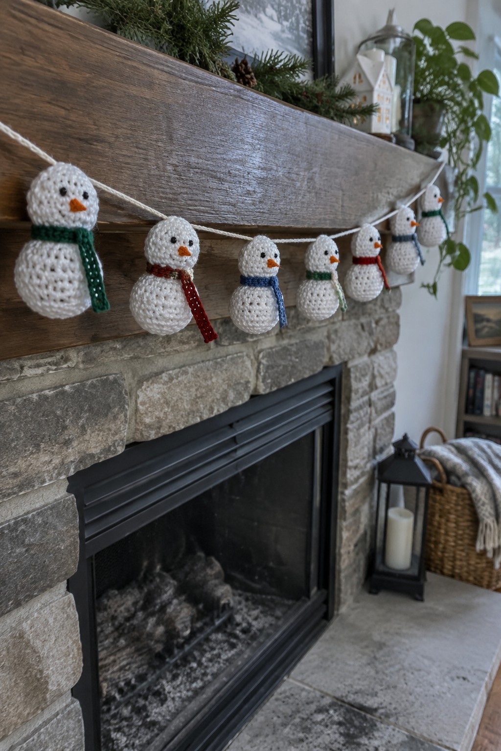 Crocheted snowmen garland with colorful scarves on wooden stone fireplace mantel