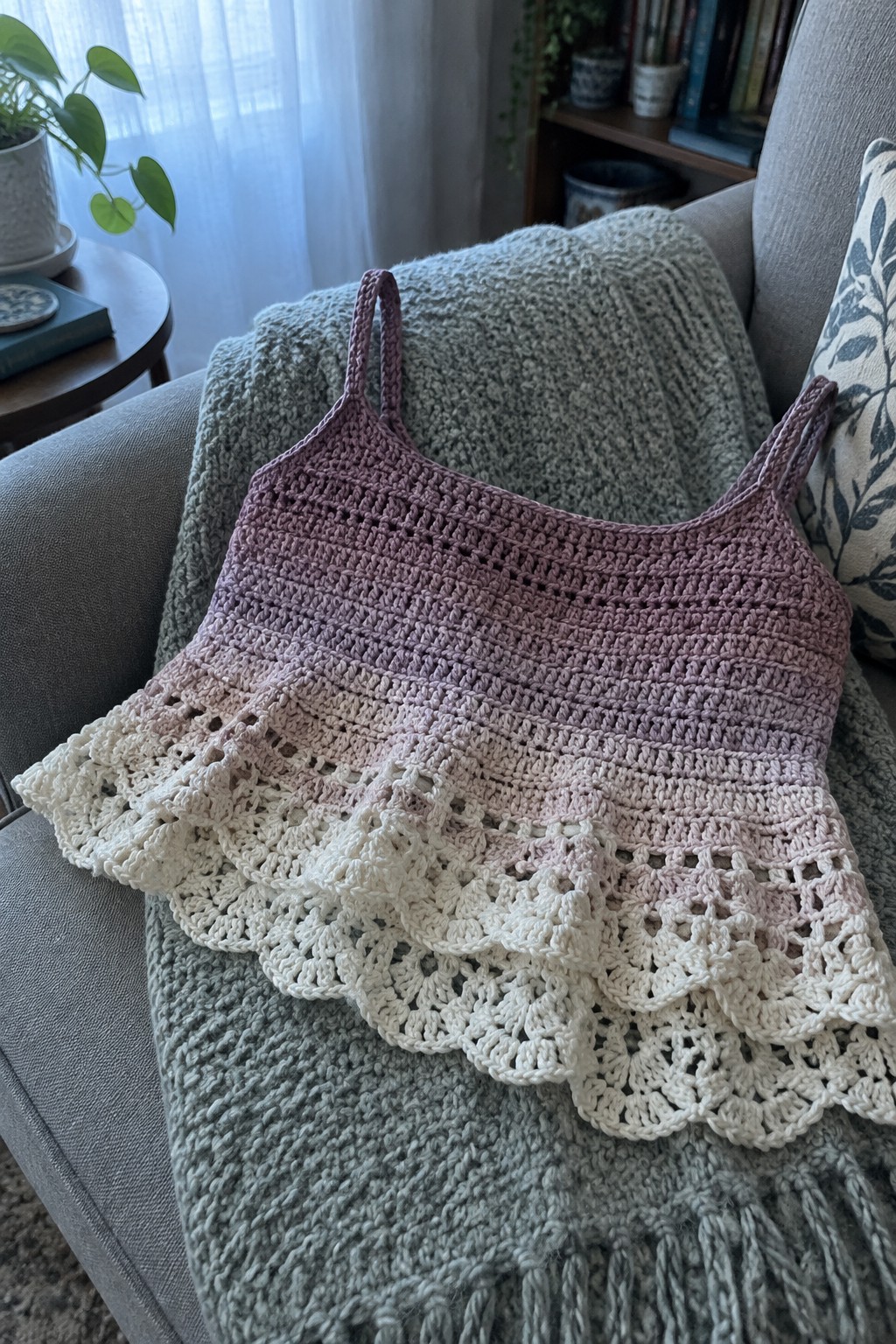 Ombre purple crocheted camisole with lacy ruffle on gray knit blanket